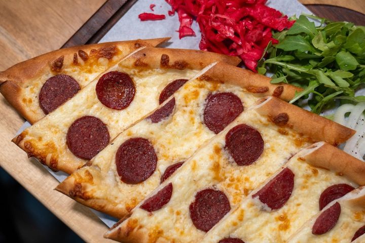 Sujuk and mozzarella pide, a classic flatbread, perfect for those exploring the best Turkish food to try.