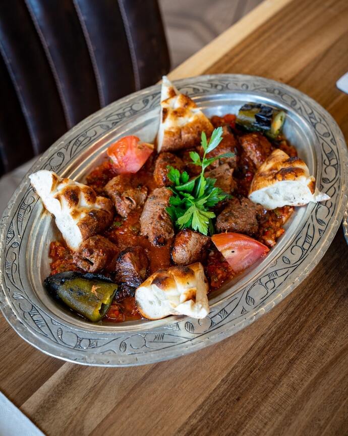 picture of meatball stew served with pita bread